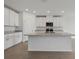 Bright modern kitchen with granite counters, stainless appliances, white cabinets, and center island at 1886 Draughton Dr, Zephyrhills, FL 33541