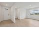Bright, open-concept living room featuring modern flooring and a large window at 1886 Draughton Dr, Zephyrhills, FL 33541