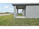 Backyard featuring a covered patio, ideal for outdoor seating with an open view of the surrounding green space at 1886 Draughton Dr, Zephyrhills, FL 33541