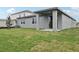 This backyard features a cozy covered patio, perfect for outdoor dining and relaxation with views of green space at 1886 Draughton Dr, Zephyrhills, FL 33541