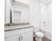 A bathroom with granite vanity, shower and tub, tiled floors, and brushed chrome fixtures at 1876 Brekey Way, Zephyrhills, FL 33541