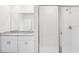 This bright bathroom features a glass-enclosed shower with white tiled walls at 1876 Brekey Way, Zephyrhills, FL 33541