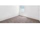 Neutral bedroom featuring carpet and a window providing natural light at 1876 Brekey Way, Zephyrhills, FL 33541