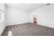 Spacious carpeted bedroom with door to bathroom and natural light at 1876 Brekey Way, Zephyrhills, FL 33541
