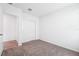 A bedroom with carpet, closet and doorway to tile floored area at 1876 Brekey Way, Zephyrhills, FL 33541