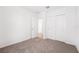 Carpeted bedroom with closet and doorway to tile floored area at 1876 Brekey Way, Zephyrhills, FL 33541