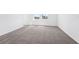 A spacious bedroom featuring neutral carpet and a neighborhood view at 1876 Brekey Way, Zephyrhills, FL 33541