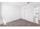 Bedroom featuring closet and an entrance showcasing wood-look flooring beyond at 1876 Brekey Way, Zephyrhills, FL 33541