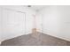 Bedroom view with double door closet and doorway leading to tiled area at 1876 Brekey Way, Zephyrhills, FL 33541