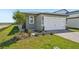 Charming single-Gathering home with a well-maintained lawn and a paved driveway leading to a two-car garage at 1876 Brekey Way, Zephyrhills, FL 33541