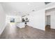 Bright, open-concept kitchen with white cabinets, island, granite countertops, and stainless steel appliances at 1876 Brekey Way, Zephyrhills, FL 33541