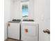 A well-lit laundry room with a new washer and dryer and vinyl floors at 1876 Brekey Way, Zephyrhills, FL 33541