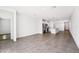 Spacious, open-concept living area with tile flooring that connects to the kitchen and dining space at 1876 Brekey Way, Zephyrhills, FL 33541