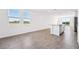Bright Living Room featuring large windows and tile floors overlooking the outdoors at 1876 Brekey Way, Zephyrhills, FL 33541