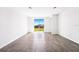 Spacious living room features tiled floors and sliding glass doors to a backyard at 1876 Brekey Way, Zephyrhills, FL 33541