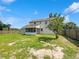 Spacious backyard with a screened porch and partial fencing, providing ample outdoor space at 4000 Barbary Ln, North Port, FL 34287