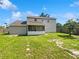 Expansive backyard with a screened-in porch, a lush lawn, and a privacy fence, offering a serene outdoor space at 4000 Barbary Ln, North Port, FL 34287