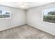 Cozy bedroom featuring plush carpet, two windows with blinds, and ample natural light at 4000 Barbary Ln, North Port, FL 34287