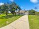 Charming single-story home with a lush green lawn and a long driveway at 4000 Barbary Ln, North Port, FL 34287