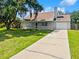 Cozy home featuring a covered porch and well-maintained front lawn at 4000 Barbary Ln, North Port, FL 34287