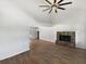 Open-concept living room with a stone fireplace, vaulted ceilings, hardwood floors, and an open view of the dining area at 4000 Barbary Ln, North Port, FL 34287