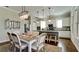 Open dining area featuring stylish lighting and a seamless flow to the modern kitchen at 4777 Royal Dornoch Cir, Bradenton, FL 34211