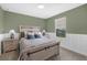 Cozy bedroom features neutral paint, a large window for natural light, and paneled accent on the lower walls at 13015 Homestead Ln, Parrish, FL 34219