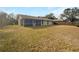 Expansive backyard view with a screened-in porch attached to the home at 14315 Knoll Ridge Dr, Tampa, FL 33625
