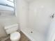 Clean and bright bathroom with a shower stall, white tile, and an efficient toilet at 14315 Knoll Ridge Dr, Tampa, FL 33625