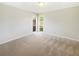 Clean, bright and roomy carpeted bedroom featuring multiple windows and neutral walls at 14315 Knoll Ridge Dr, Tampa, FL 33625