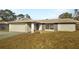 Charming single-story home featuring a stone facade, attached garage, and well-maintained lawn at 14315 Knoll Ridge Dr, Tampa, FL 33625