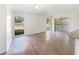 A bright, open living room with wood flooring, large windows and access to the screened in lanai at 14315 Knoll Ridge Dr, Tampa, FL 33625