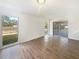 A bright, open living room with wood flooring, large windows and access to the screened in lanai at 14315 Knoll Ridge Dr, Tampa, FL 33625