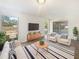 Well-decorated living room filled with modern furniture and a striped rug on hardwood floors at 14315 Knoll Ridge Dr, Tampa, FL 33625