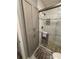 Modern bathroom featuring a glass shower with tiled walls, built in shelving and a storage cabinet at 500 The Esplanade N # 405, Venice, FL 34285
