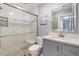 Updated bathroom featuring a glass-enclosed shower, modern vanity, and tiled backsplash at 500 The Esplanade N # 405, Venice, FL 34285