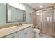 Bright bathroom showcasing a glass-enclosed shower, vanity with stone countertop, and modern fixtures at 500 The Esplanade N # 405, Venice, FL 34285