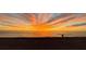 Serene beach view with an orange sunset reflecting on the ocean with a couple walking by the shore at 500 The Esplanade N # 405, Venice, FL 34285