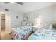 Light-filled bedroom featuring two twin beds, white dresser, and nautical-themed decor at 500 The Esplanade N # 405, Venice, FL 34285