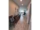 Hallway leading to the living area features a tiled floor and neutral decor at 500 The Esplanade N # 405, Venice, FL 34285