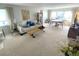 Inviting living room featuring neutral tones, large windows with bright natural light, and cozy seating area at 500 The Esplanade N # 405, Venice, FL 34285