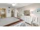 Tranquil bedroom featuring a dresser, beach decor, and ensuite bathroom at 500 The Esplanade N # 405, Venice, FL 34285