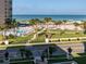 Stunning ocean view showcasing the pool, palm trees, and beach, with a glimpse of the community at 500 The Esplanade N # 405, Venice, FL 34285