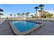 Outdoor pool surrounded by palm trees and lounge chairs at 500 The Esplanade N # 405, Venice, FL 34285