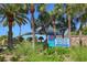 Welcome to Venice Beach sign, set amidst lush greenery and swaying palm trees at 500 The Esplanade N # 405, Venice, FL 34285