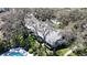 Aerial view of the property featuring a private backyard oasis surrounded by mature trees at 4215 Edgewood Dr, Holiday, FL 34691