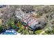 Aerial view of home nestled among mature trees with a pool in the backyard at 4215 Edgewood Dr, Holiday, FL 34691