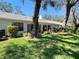 View of the backyard, patio, and rear exterior of the home at 4215 Edgewood Dr, Holiday, FL 34691