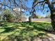 Large backyard featuring lush grass, a storage shed, and a privacy fence at 4215 Edgewood Dr, Holiday, FL 34691