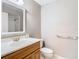Simple bathroom featuring a vanity, mirror, and neutral colors at 4215 Edgewood Dr, Holiday, FL 34691